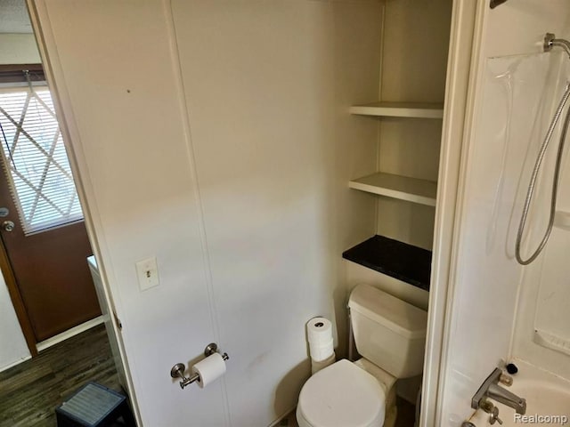 bathroom featuring a wealth of natural light, wood-type flooring, and toilet