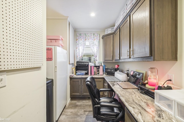 office with hardwood / wood-style floors and crown molding