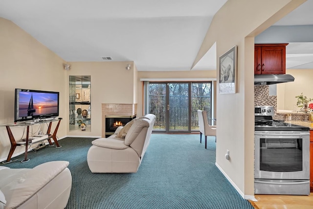 carpeted living room featuring lofted ceiling