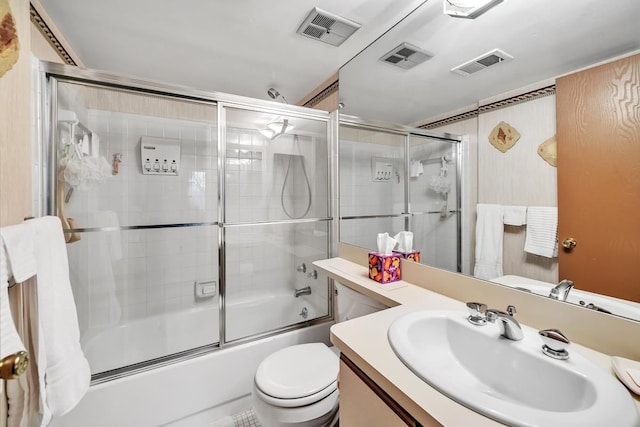 full bathroom with vanity, enclosed tub / shower combo, and toilet