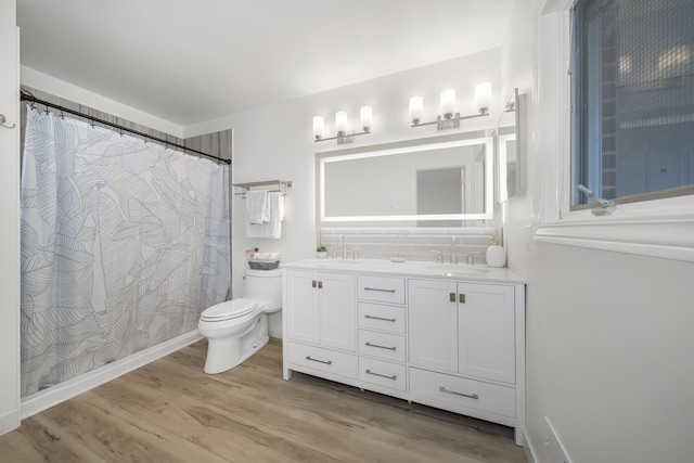 bathroom with hardwood / wood-style floors, vanity, and toilet