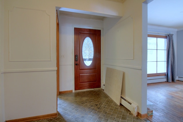 foyer entrance with dark hardwood / wood-style floors, crown molding, and a baseboard heating unit