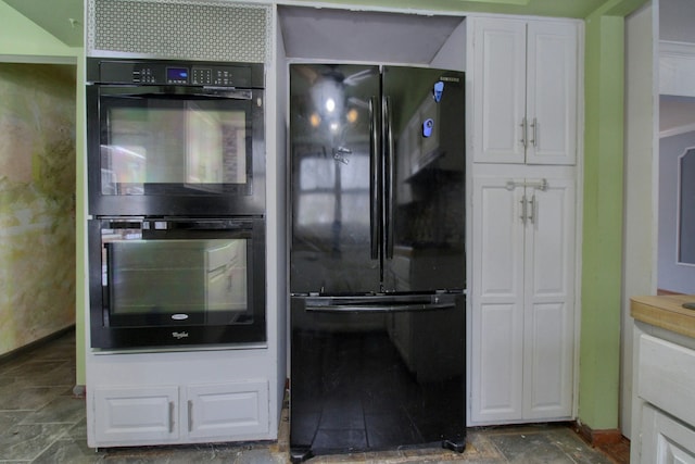 kitchen featuring white cabinets and black appliances