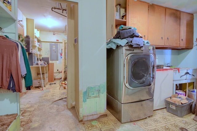 clothes washing area featuring washer / clothes dryer, electric panel, and cabinets