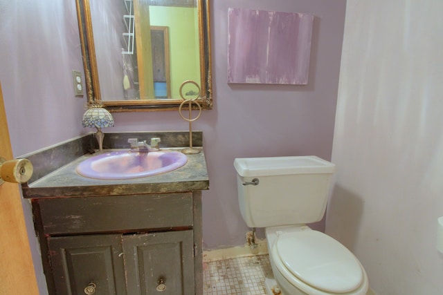 bathroom with tile patterned floors, vanity, and toilet