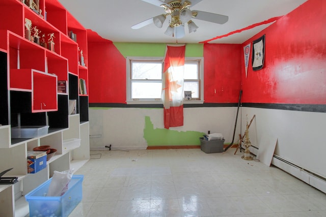 bathroom with ceiling fan and a baseboard heating unit