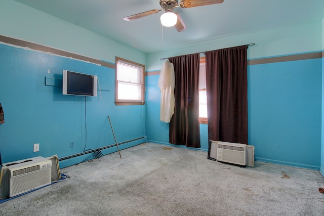 carpeted empty room with baseboard heating, a wall mounted AC, and ceiling fan