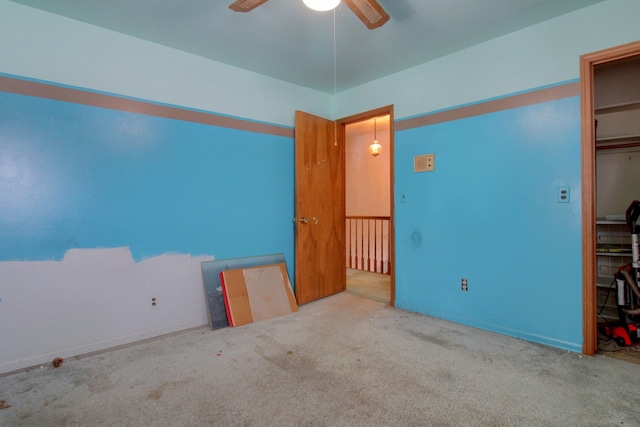 unfurnished bedroom with ceiling fan, carpet floors, and a closet