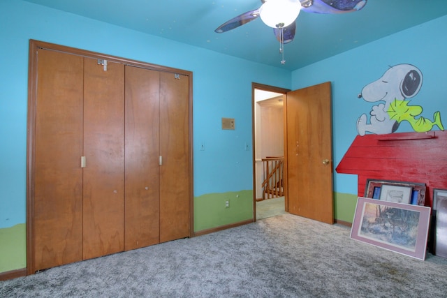 unfurnished bedroom with ceiling fan, light colored carpet, and a closet