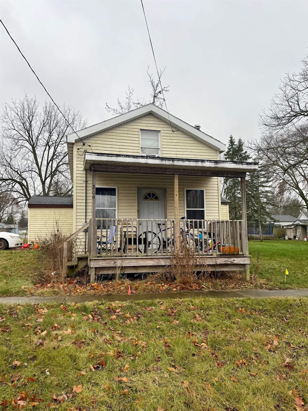 bungalow-style house with covered porch and a front lawn