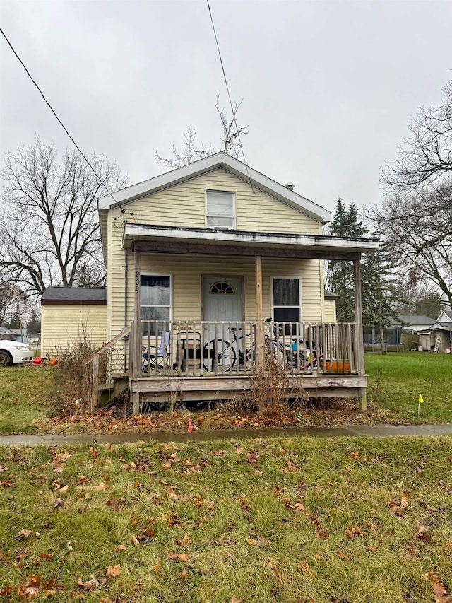 bungalow-style house with covered porch and a front lawn