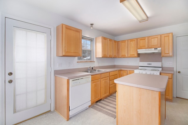 kitchen featuring light brown cabinetry, white appliances, a center island, and sink