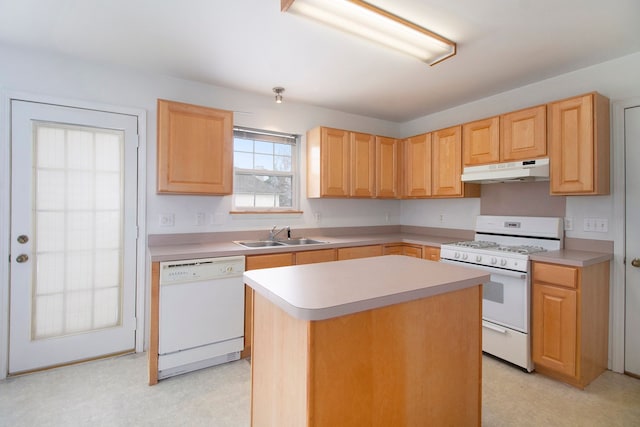 kitchen with light brown cabinets, white appliances, a center island, and sink