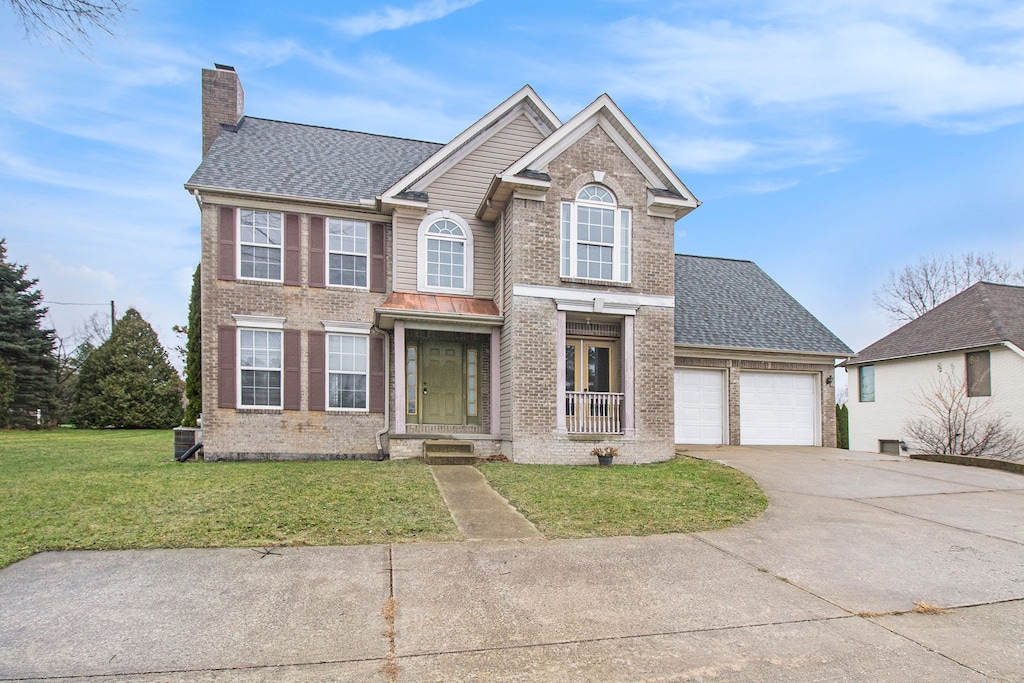 view of front of house featuring a garage and a front lawn