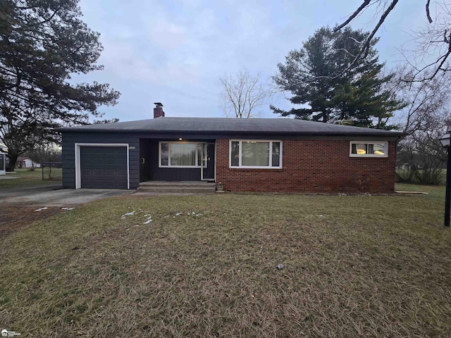 ranch-style home with a garage and a front lawn