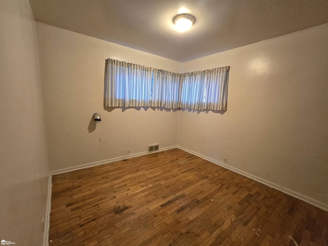 unfurnished room featuring dark hardwood / wood-style floors