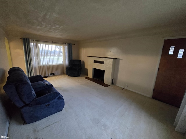 carpeted living room featuring a textured ceiling