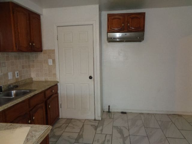 kitchen with decorative backsplash and sink