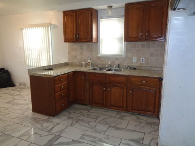 kitchen with tasteful backsplash and sink