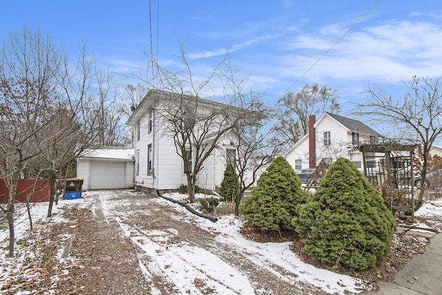 view of snow covered exterior with a garage