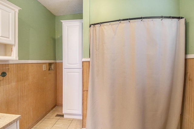 bathroom with tile patterned floors and a textured ceiling