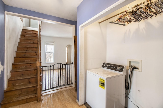 laundry room with light wood-type flooring and washer / clothes dryer