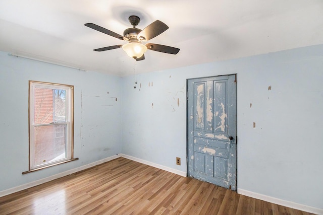 spare room featuring ceiling fan and light wood-type flooring