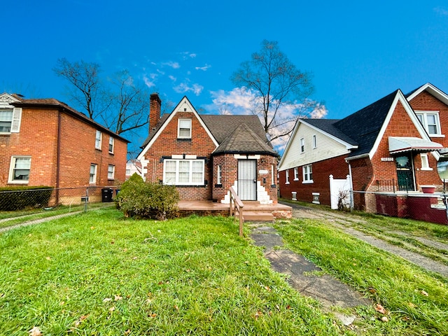 tudor-style house with a front lawn