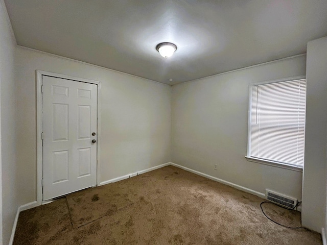carpeted empty room with baseboards