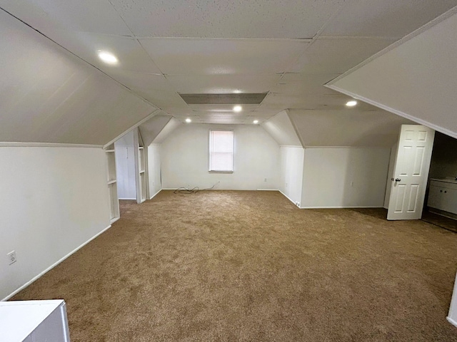 bonus room with carpet floors and lofted ceiling