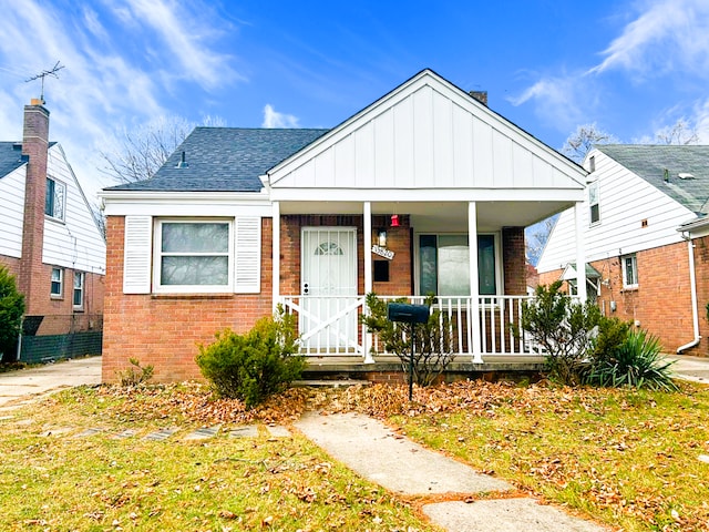 bungalow featuring a front yard and a porch