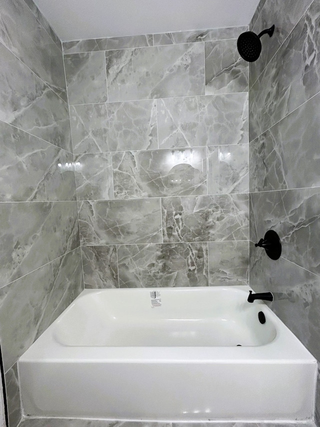 bathroom featuring tiled shower / bath