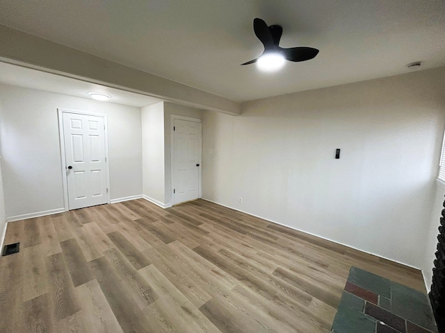 unfurnished bedroom featuring ceiling fan, wood-type flooring, and a closet