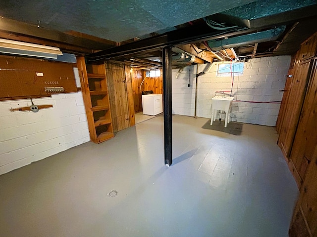 basement featuring independent washer and dryer and sink