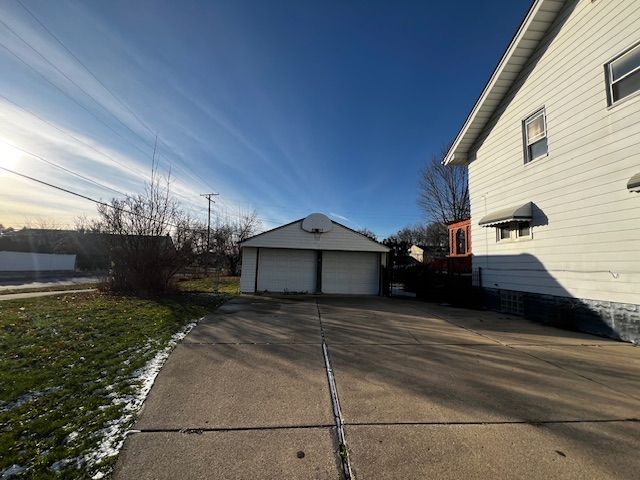 view of home's exterior with a garage and an outdoor structure