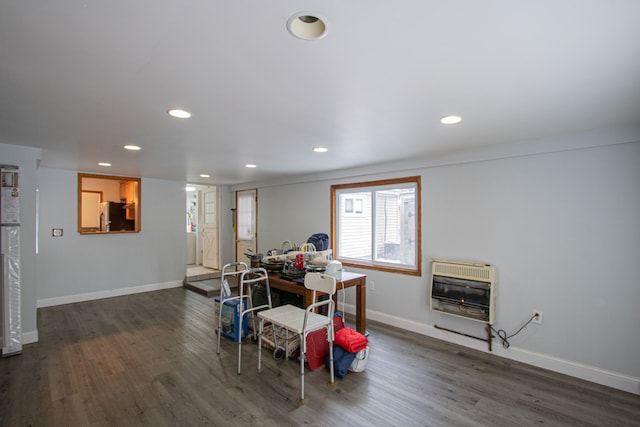 dining space with heating unit and dark hardwood / wood-style flooring