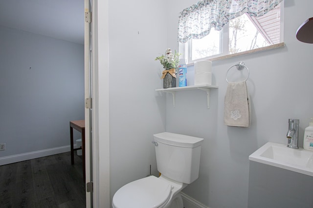 bathroom with hardwood / wood-style flooring, sink, and toilet