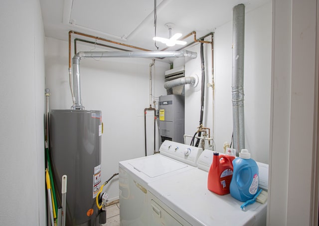 washroom featuring water heater and washing machine and clothes dryer