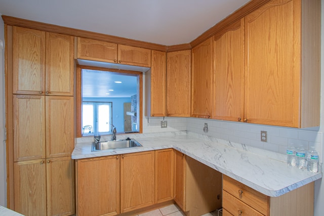 kitchen with light tile patterned floors, sink, and tasteful backsplash