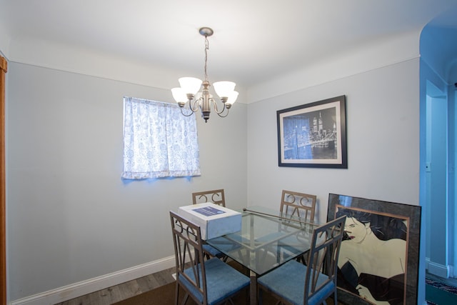 dining space with a chandelier and wood-type flooring