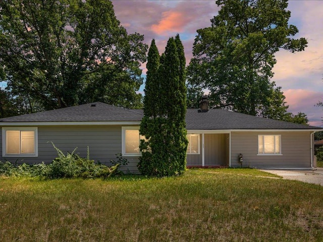 ranch-style home with a yard