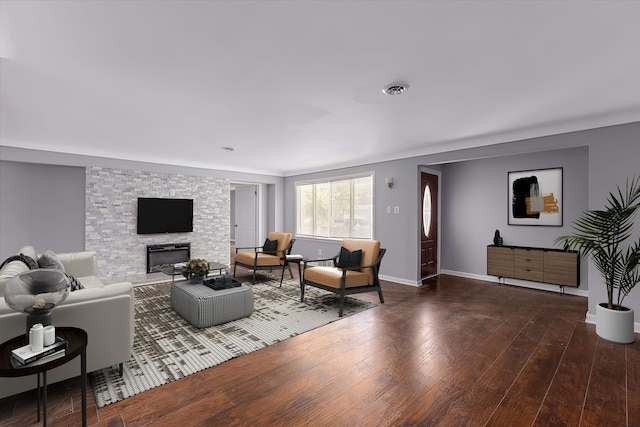 living room featuring dark hardwood / wood-style floors and a fireplace