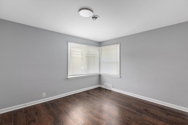 empty room with dark hardwood / wood-style flooring