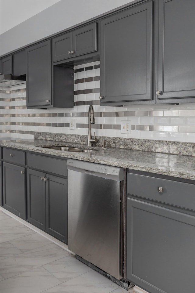 kitchen with gray cabinets, decorative backsplash, dishwasher, and sink