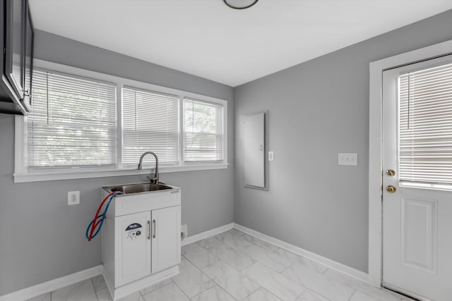 laundry room featuring a healthy amount of sunlight, cabinets, sink, and hookup for a washing machine