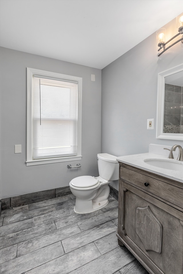 bathroom featuring vanity, toilet, and wood-type flooring