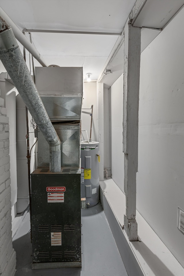 utility room with heating unit and water heater