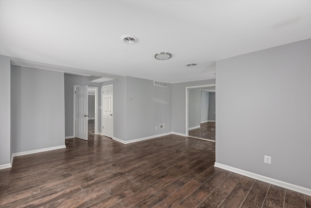 empty room with dark wood-type flooring