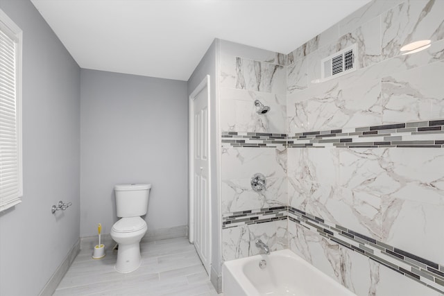 bathroom featuring a washtub, wood-type flooring, and toilet