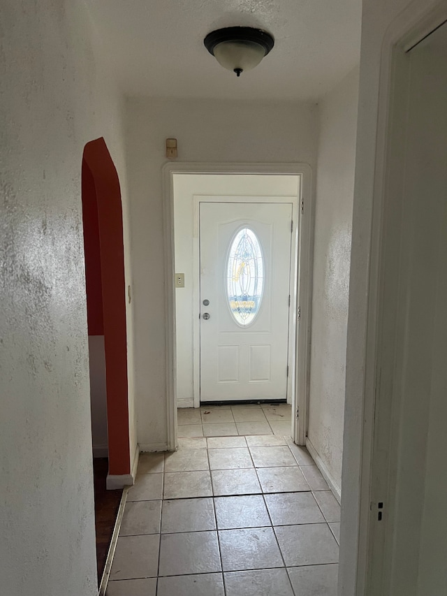 doorway to outside featuring light tile patterned floors